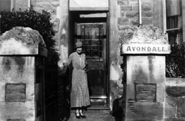 I do not know who this is, outside a house named Avondale. It is a member of the Baker family.
