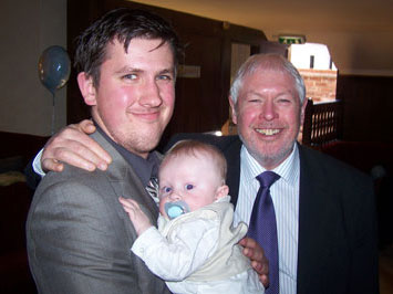 Richard Holland holding his nephew/grandson Finley Holland, alongside his father Philip Holland.