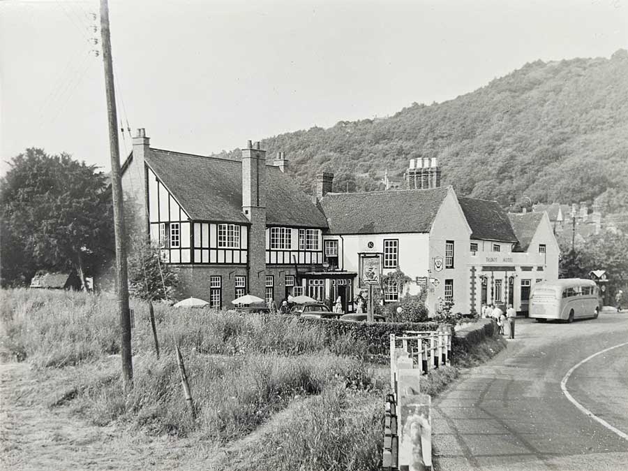 Photo of the Talbot Hotel, 17th July, 1955. A coach is stood outside the front, and you can see the AA man by the old AA box.