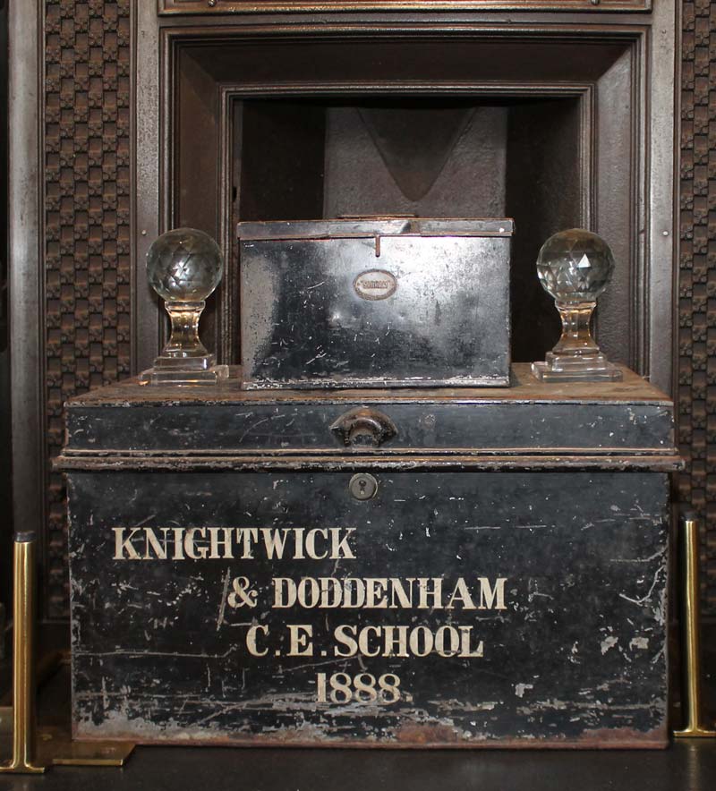 This photo shows the black box that contains the historical documents with regards the school at Knightwick, sitting in one of the two fireplaces of the main school room.