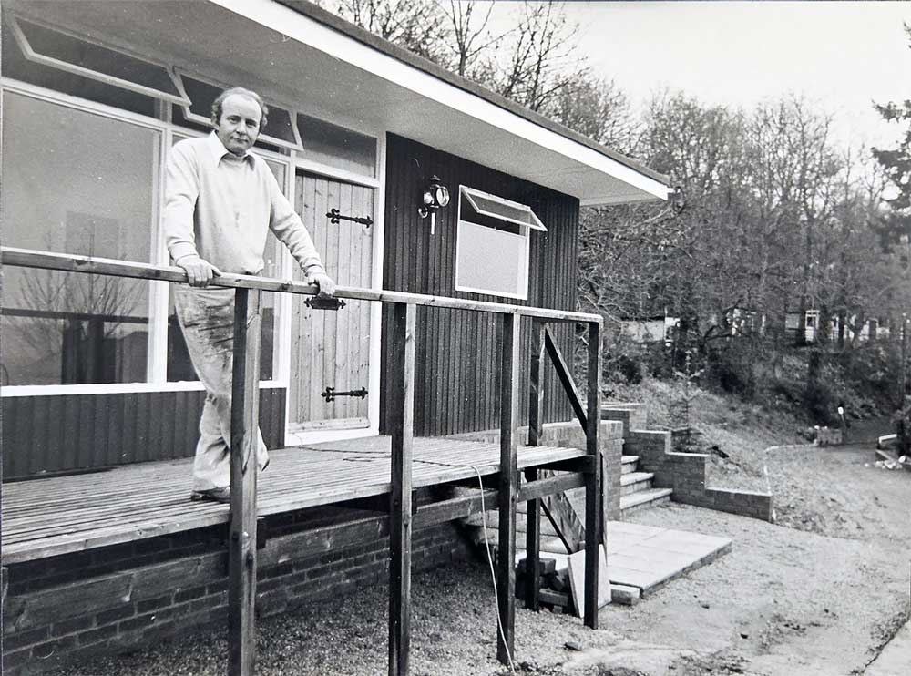 Mr Cyril Haynes, property developer standing by one of the former delapidated homeless family chalets which he's restored and offering for sale.