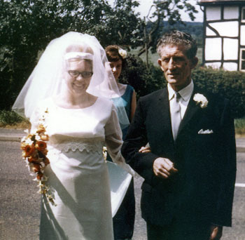 Josephine arriving with her father, Ted Holland, at St Mary's Church, Knightwick, Worcestershire. Behind is Geraldine Chaplin (Jo's friend and bridesmaid).